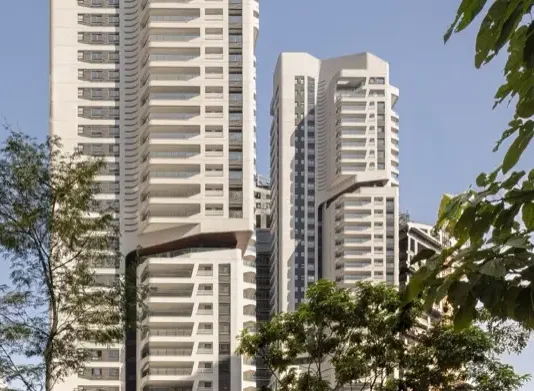 Rascacielos residenciales EZ Parque da Cidade en São Paulo, vistas entre árboles.