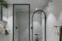 Ducha en apartamento dúplex con decoración oscura.